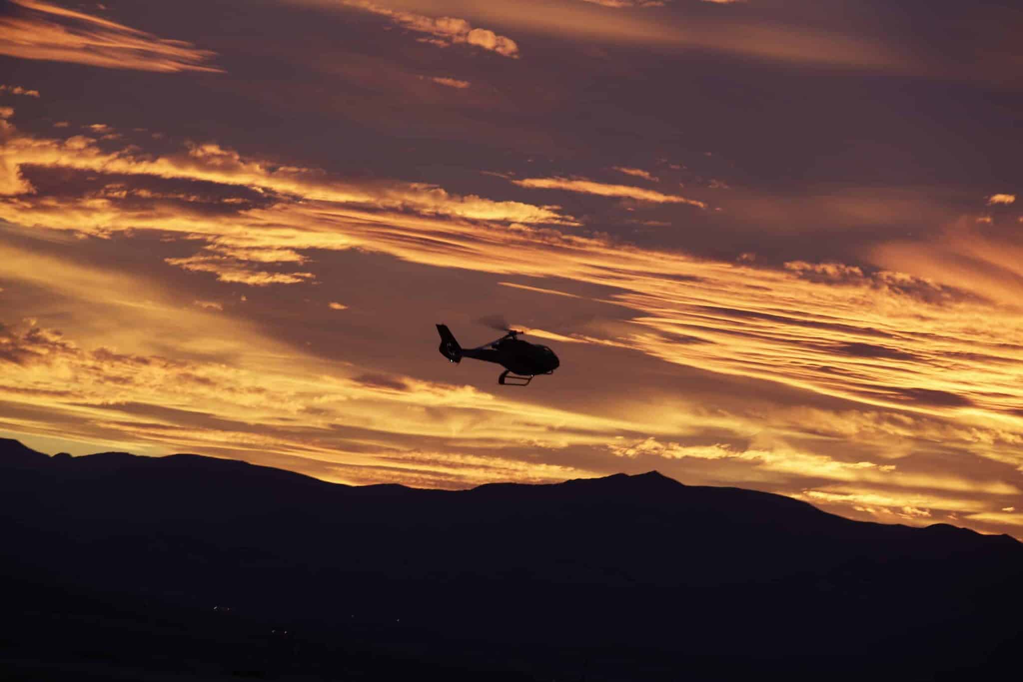 Helicopter flying over Las Vegas at sunset