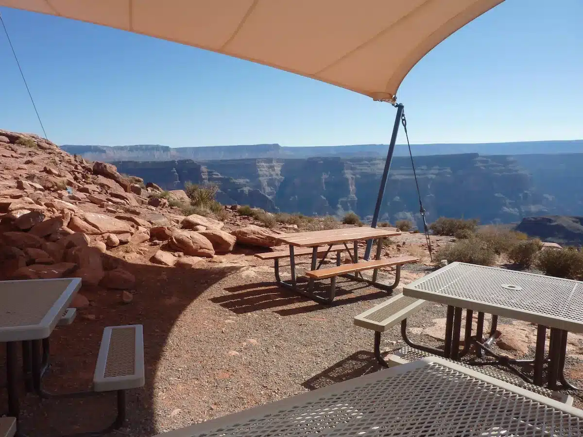 Group tours image Shaded picnic tables on the Grand Canyon rim set up for a group