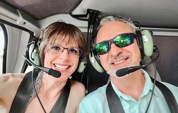 Not Sure Which Tour image Couple wearing headsets smiling inside a GC Flight helicopter